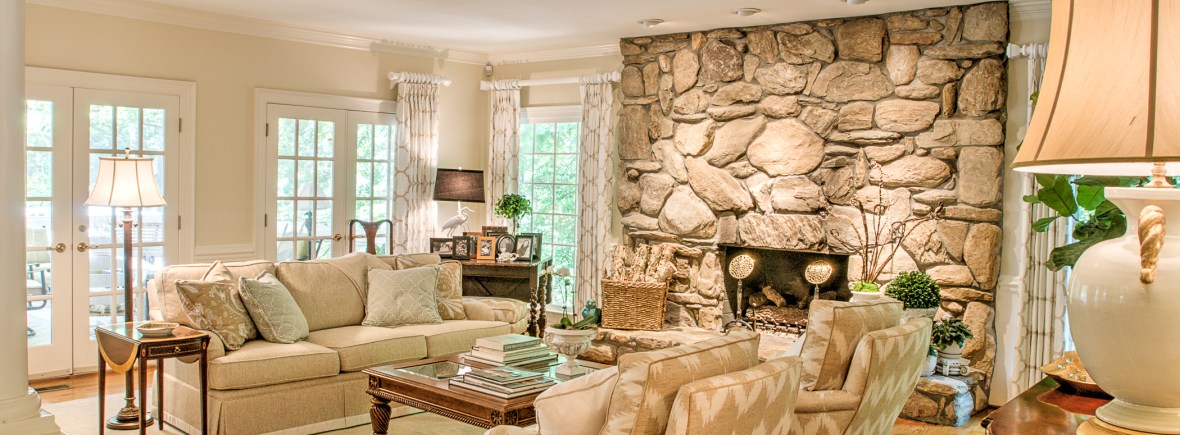 taupe beige sofa chairs stone fireplace