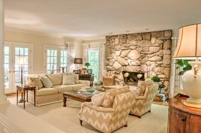 taupe beige sofa chairs stone fireplace